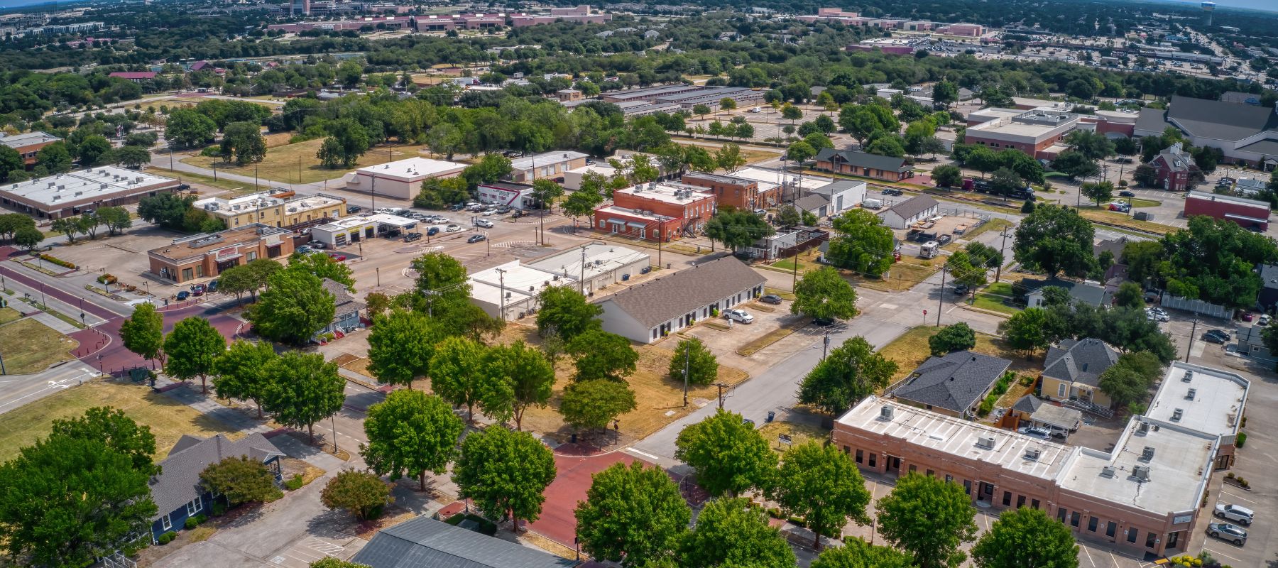 Aerial view of downtown Allen, Texas with tree-lined streets and small businesses