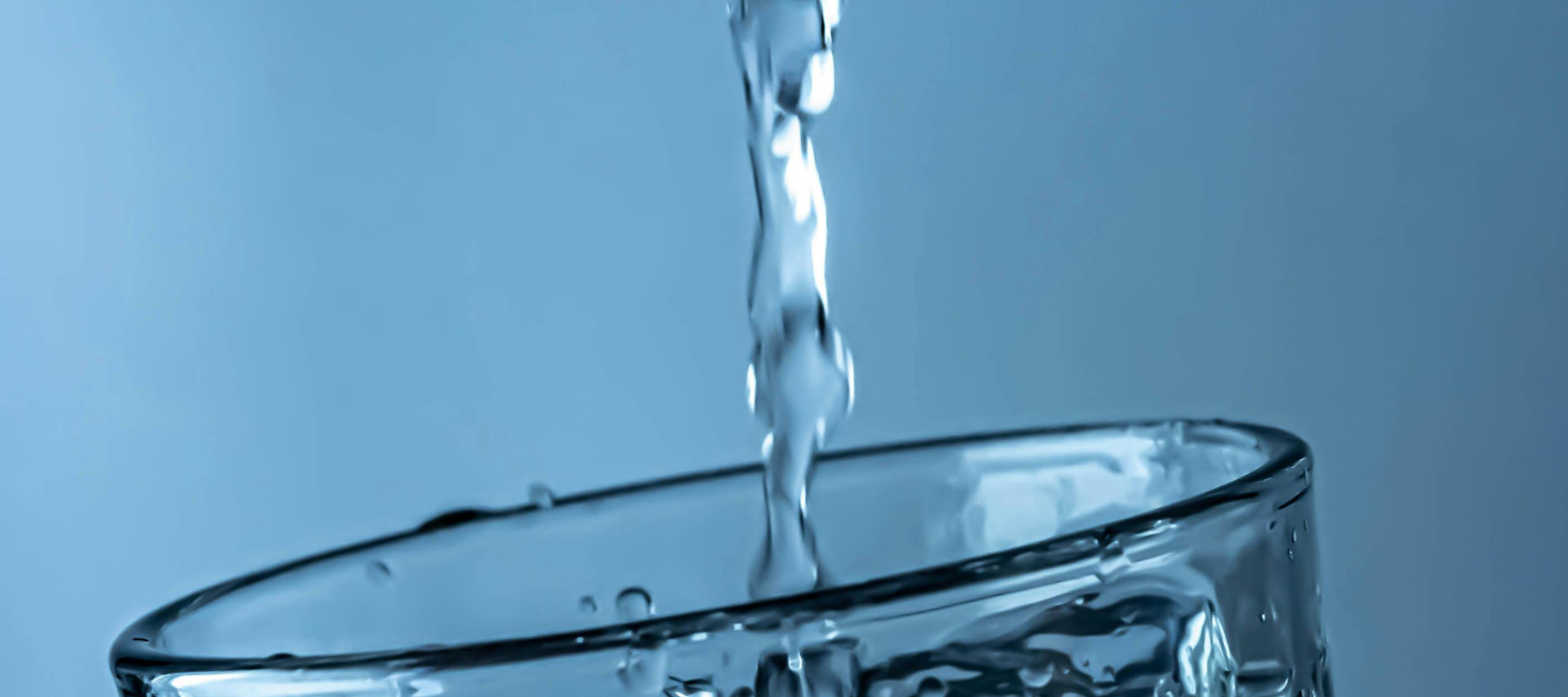 Clear water going into a glass.